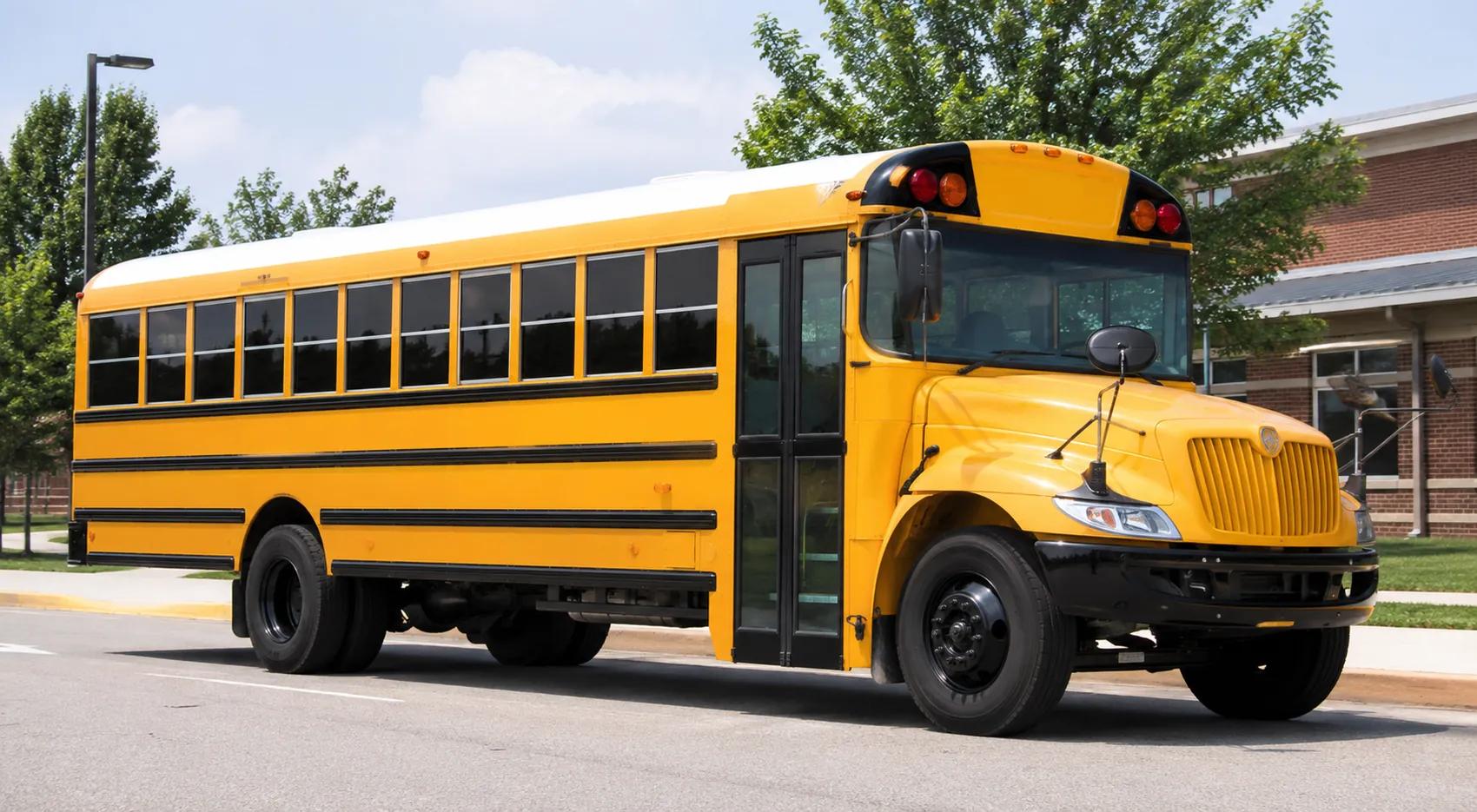 Yellow school bus parked outside a school